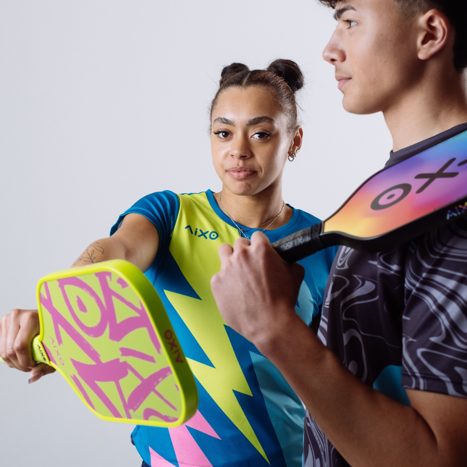 Action shot of players with AIXO Ghost Prism Break paddle — energetic, stylish, and ready to dominate every rally.