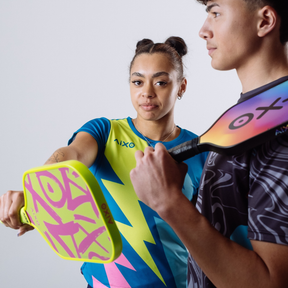 Action shot of players with AIXO Ghost Prism Break paddle — energetic, stylish, and ready to dominate every rally.